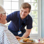 an NDIS registered social worker providing assistance to an elderly man